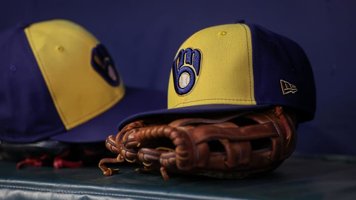 Jul 28, 2023; Atlanta, Georgia, USA; A detailed view of a Milwaukee Brewers hat and glove on the bench against the Atlanta Braves in the second inning at Truist Park. Mandatory Credit: Brett Davis-Imagn Images