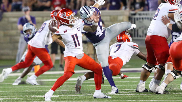 Sep 13, 2024; Manhattan, Kansas, USA; Arizona Wildcats quarterback Noah Fifita (11) passes the ball while being rushed by Kansas State Wildcats linebacker Austin Moore (41) at Bill Snyder Family Football Stadium. Mandatory Credit: Scott Sewell-Imagn Images