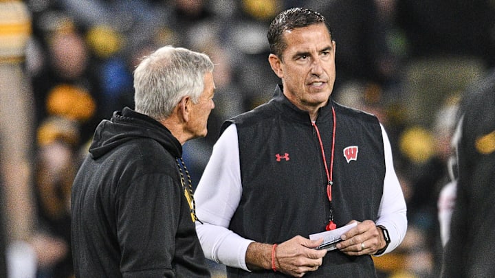 Nov 2, 2024; Iowa City, Iowa, USA; Iowa Hawkeyes head coach Kirk Ferentz (left) and Wisconsin Badgers head coach Luke Fickell (right) talk before the game at Kinnick Stadium. 