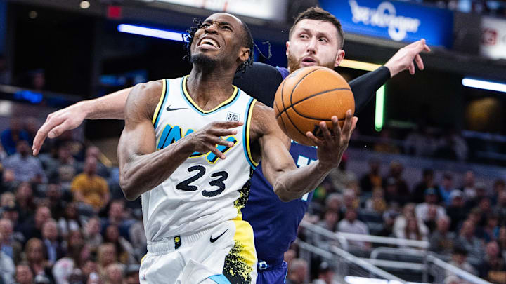 Apr 2, 2025; Indianapolis, Indiana, USA; Indiana Pacers forward Aaron Nesmith (23) shoots the ball while Charlotte Hornets center Jusuf Nurkic (11) defends in the second half at Gainbridge Fieldhouse. Mandatory Credit: Trevor Ruszkowski-Imagn Images