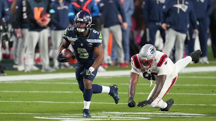 Feb 8, 2026; Santa Clara, CA, USA; Seattle Seahawks running back Kenneth Walker III (9) runs the ball as New England Patriots defensive tackle Christian Barmore (90) defends during the third quarter in Super Bowl LX at Levi's Stadium. Mandatory Credit: Cary Edmondson-Imagn Images