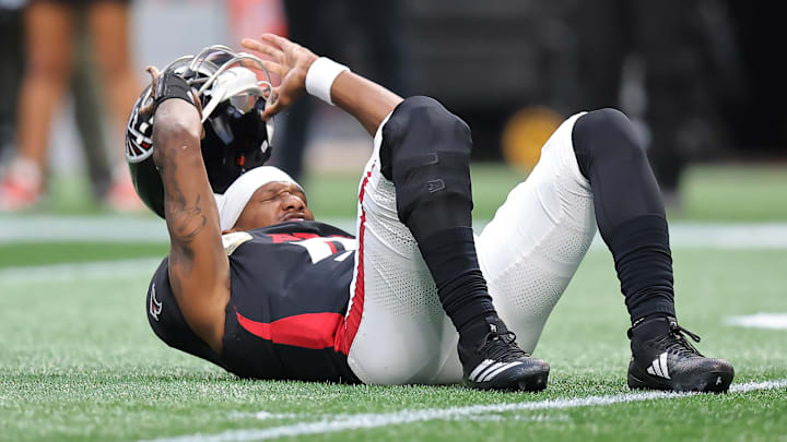 Michael Penix Jr. of the Atlanta Falcons takes his helmet off after a play against the Carolina Panthers. Michael Penix Jr. of the Atlanta Falcons takes his helmet off after a play against the Carolina Panthers.