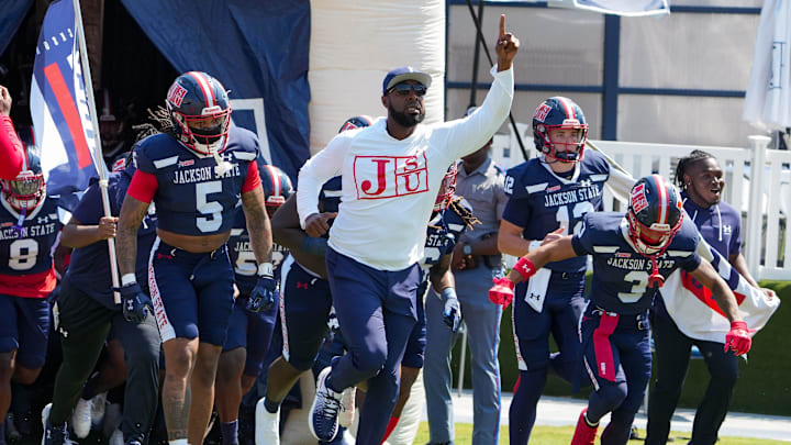 Jackson State Head Coach T.C. Taylor leads the team onto the field at the start of the game against the Tuskegee Golden Tigers