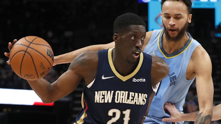 Apr 9, 2022; Memphis, Tennessee, USA; New Orleans Pelicans forward Tony Snell (21) dribbles the ball against Memphis Grizzlies forward Kyle Anderson (1) during the second half at FedExForum. Mandatory Credit: Christine Tannous-Imagn Images