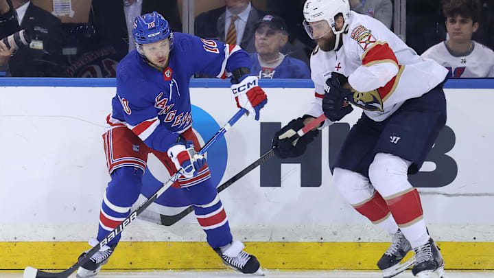 May 22, 2024; New York, New York, USA; New York Rangers left wing Artemi Panarin (10) controls the puck against Florida Panthers defenseman Aaron Ekblad (5) during the third period of game one of the Eastern Conference Final of the 2024 Stanley Cup Playoffs at Madison Square Garden. Mandatory Credit: Brad Penner-USA TODAY Sports