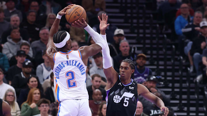 Nov 21, 2025; Salt Lake City, Utah, USA; Oklahoma City Thunder guard Shai Gilgeous-Alexander (2) shoots as Utah Jazz forward Cody Williams (5) defends during the second half at Delta Center. Mandatory Credit: Rob Gray-Imagn Images
