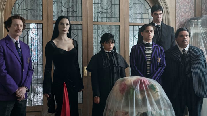 (L to R) Steve Buscemi as Barry Dort, Catherine Zeta-Jones as Morticia Addams, Jenna Ortega as Wednesday Addams, Isaac Ordonez as Pugsley Addams, Joonas Suotamo as Lurch, and Luis Guzmán as Gomez Addams in episode 201 of Wednesday