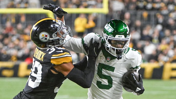 Oct 20, 2024; Pittsburgh, Pennsylvania, USA; Pittsburgh Steelers safety Minkah Fitzpatrick (39) tackles New York Jets wide receiver Garrett Wilson (5) during the first quarter at Acrisure Stadium. 