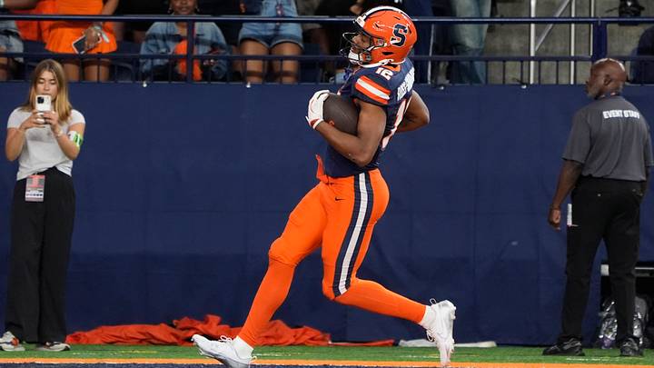 Sep 6, 2025; Syracuse, New York, USA; Syracuse Orange wide receiver Justus Ross-Simmons (12) scores a touchdown against the UConn Huskies during the second half at JMA Wireless Dome. Mandatory Credit: Gregory Fisher-Imagn Images Sep 6, 2025; Syracuse, New York, USA; Syracuse Orange wide receiver Justus Ross-Simmons (12) scores a touchdown against the UConn Huskies during the second half at JMA Wireless Dome. Mandatory Credit: Gregory Fisher-Imagn Images