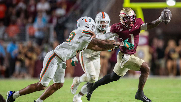 Florida State Seminoles quarterback Tommy Castellanos (1) fights off a defender as he makes his way down the field. The Miami Hurricanes defeated the Florida State Seminoles 22-28 at Doak Campbell Stadium on Saturday, Oct. 4, 2025. Florida State Seminoles quarterback Tommy Castellanos (1) fights off a defender as he makes his way down the field. The Miami Hurricanes defeated the Florida State Seminoles 22-28 at Doak Campbell Stadium on Saturday, Oct. 4, 2025.