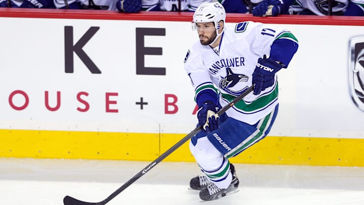 Dec 29, 2013; Calgary, Alberta, CAN; Vancouver Canucks center Ryan Kesler (17) passes the puck against the Calgary Flames during the first period at Scotiabank Saddledome. Vancouver Canucks won 2-0. Mandatory Credit: Sergei Belski-Imagn Images Dec 29, 2013; Calgary, Alberta, CAN; Vancouver Canucks center Ryan Kesler (17) passes the puck against the Calgary Flames during the first period at Scotiabank Saddledome. Vancouver Canucks won 2-0. Mandatory Credit: Sergei Belski-Imagn Images