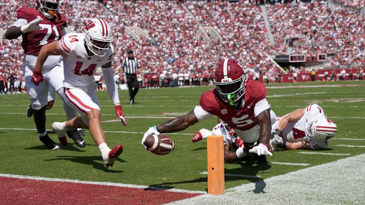Sep 13, 2025; Tuscaloosa, Alabama, USA;  Alabama wide receiver Germie Bernard (5) dives for a score at the pylon with Wisconsin defensive back Preston Zachman (14),  defensive back D'Yoni Hill (5) and linebacker Tackett Curtis (4) unable to make the stop at Saban Field at Bryant-Denny Stadium. Mandatory Credit: Gary Cosby-USA TODAY Network via Imagn Images