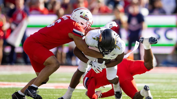 Oct 19, 2024; Tucson, Arizona, USA; Arizona Wildcats linebacker Taye Brown (6) tackles Colorado Buffalos running back Dallan Hayden (7) at Arizona Stadium. Mandatory Credit: Mark J. Rebilas-Imagn Images