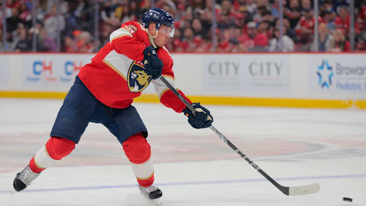 Apr 8, 2025; Sunrise, Florida, USA; Florida Panthers defenseman Nate Schmidt (88) shoots the puck against the Toronto Maple Leafs during the second period at Amerant Bank Arena. Mandatory Credit: Sam Navarro-Imagn Images