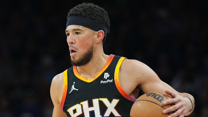 Apr 3, 2024; Phoenix, Arizona, USA; Phoenix Suns guard Devin Booker (1) dribbles against the Cleveland Cavaliers during the first half at Footprint Center. Mandatory Credit: Joe Camporeale-Imagn Images