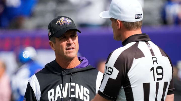 Oct 16, 2022; East Rutherford, New Jersey, USA; Baltimore Ravens head coach John Harbaugh speaks with an official before playing against the New York Giants at MetLife Stadium. Mandatory Credit: Robert Deutsch-Imagn Images