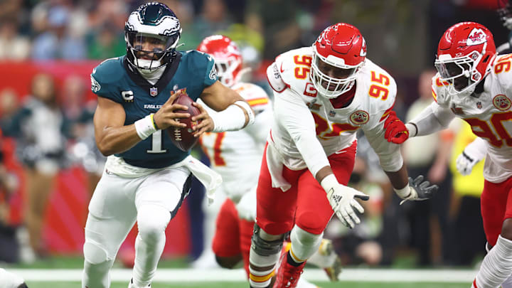 Feb 9, 2025; New Orleans, LA, USA; Philadelphia Eagles quarterback Jalen Hurts (1) runs past Kansas City Chiefs defensive tackle Chris Jones (95) in the second half in Super Bowl LIX at Ceasars Superdome. Mandatory Credit: Mark J. Rebilas-Imagn Images