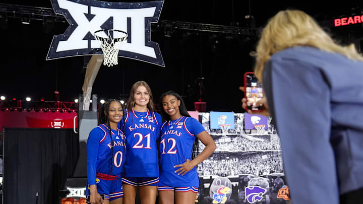 Oct 22, 2024; Kansas City, MO, USA; Kansas Jayhawks guard Wyvette Mayberry (0) and guard Elle Evans (21) and guard S’Mya Nichols (12) pose for a photo during Big 12 Women’s Basketball Media Day at T-Mobile Center. Mandatory Credit: Jay Biggerstaff-Imagn Images
