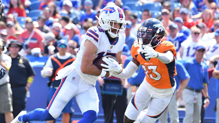 Aug 20, 2022; Orchard Park, New York, USA; Buffalo Bills wide receiver Jake Kumerow (15) turns upfield after a catch as Denver Broncos cornerback Michael Ojemudia (13) looks to make a tackle in the second quarter of a pre-season game at Highmark Stadium. Aug 20, 2022; Orchard Park, New York, USA; Buffalo Bills wide receiver Jake Kumerow (15) turns upfield after a catch as Denver Broncos cornerback Michael Ojemudia (13) looks to make a tackle in the second quarter of a pre-season game at Highmark Stadium.