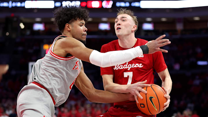 Feb 17, 2026; Columbus, Ohio, USA; Wisconsin Badgers guard Andrew Rohde (7) controls the ball as Ohio State Buckeyes guard Puff Johnson (6) defends during the first half at Value City Arena.
