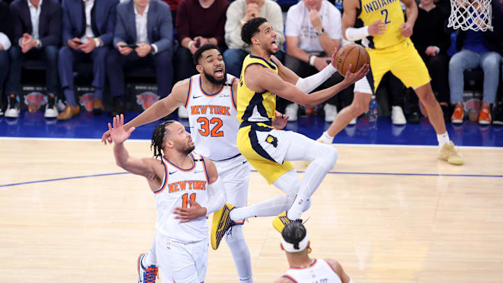 May 21, 2025; New York, New York, USA; Indiana Pacers guard Tyrese Haliburton (0) shoots against New York Knicks guard Jalen Brunson (11) and center Karl-Anthony Towns (32) in the first quarter during game one of the eastern conference finals for the 2025 NBA Playoffs at Madison Square Garden. Mandatory Credit: Wendell Cruz-Imagn Images