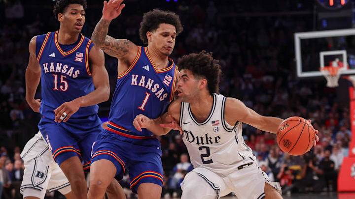 Nov 18, 2025; New York, New York, USA; Duke Blue Devils guard Cayden Boozer (2) dribbles as Kansas Jayhawks guard Jayden Dawson (1) defends during the second half at Madison Square Garden. Mandatory Credit: Vincent Carchietta-Imagn Images