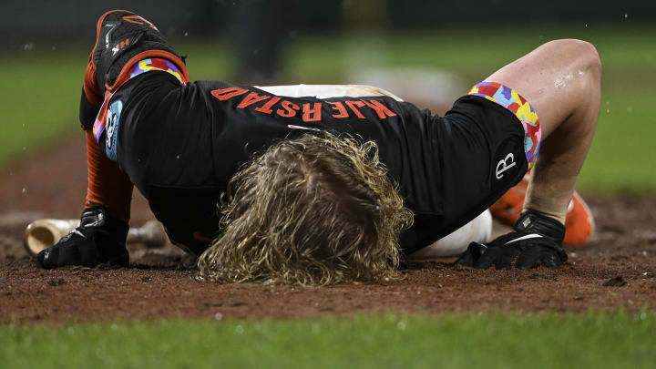 Jul 12, 2024; Baltimore, Maryland, USA;  Baltimore Orioles outfielder Heston Kjerstad (13) lays on the ground after being hit by a pitch in the head during the ninth inning against the New York Yankees at Oriole Park at Camden Yards