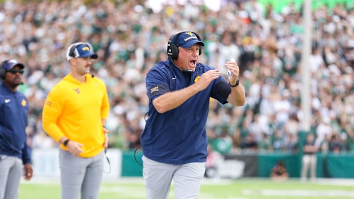 Sep 6, 2025; Athens, Ohio, USA; West Virginia Mountaineers head coach Rich Rodriguez calls a timeout during the second quarter against the Ohio Bobcats at Peden Stadium. Mandatory Credit: Ben Queen-Imagn Images