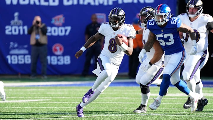 Oct 16, 2022; East Rutherford, New Jersey, USA; Baltimore Ravens quarterback Lamar Jackson (8) runs with the ball against New York Giants linebacker Oshane Ximines (53) during the second half at MetLife Stadium. Mandatory Credit: Robert Deutsch-Imagn Images Oct 16, 2022; East Rutherford, New Jersey, USA; Baltimore Ravens quarterback Lamar Jackson (8) runs with the ball against New York Giants linebacker Oshane Ximines (53) during the second half at MetLife Stadium. Mandatory Credit: Robert Deutsch-Imagn Images