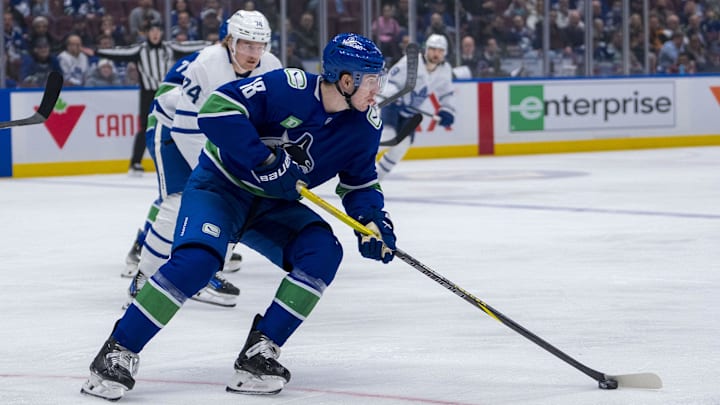 Feb 8, 2025; Vancouver, British Columbia, CAN; Vancouver Canucks forward Drew O'Connor (18) handles the puck against the Toronto Maple Leafs in the first period at Rogers Arena. Mandatory Credit: Bob Frid-Imagn Images