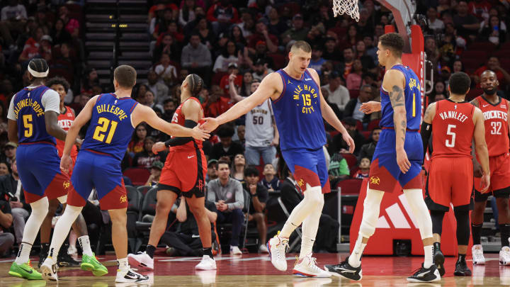 Nov 12, 2023; Houston, Texas, USA; Denver Nuggets guard Collin Gillespie (21) reacts to center Nikola Jokic (15) basket against the Houston Rockets in the second quarter at Toyota Center. Mandatory Credit: Thomas Shea-USA TODAY Sports