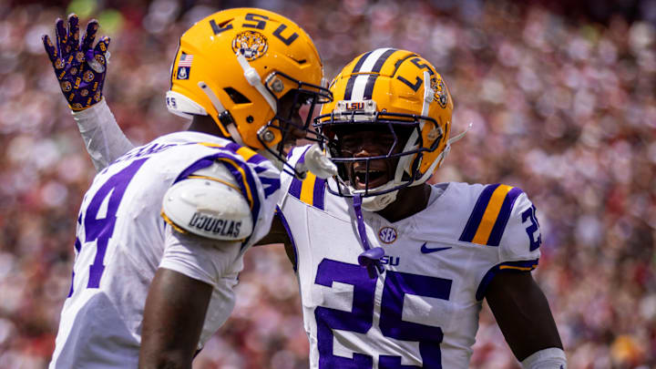 Sep 14, 2024; Columbia, South Carolina, USA; LSU Tigers cornerback Javien Toviano (25) celebrates with cornerback Zy Alexander (14) after an interception against the South Carolina Gamecocks in the first quarter at Williams-Brice Stadium. Mandatory Credit: Scott Kinser-Imagn Images