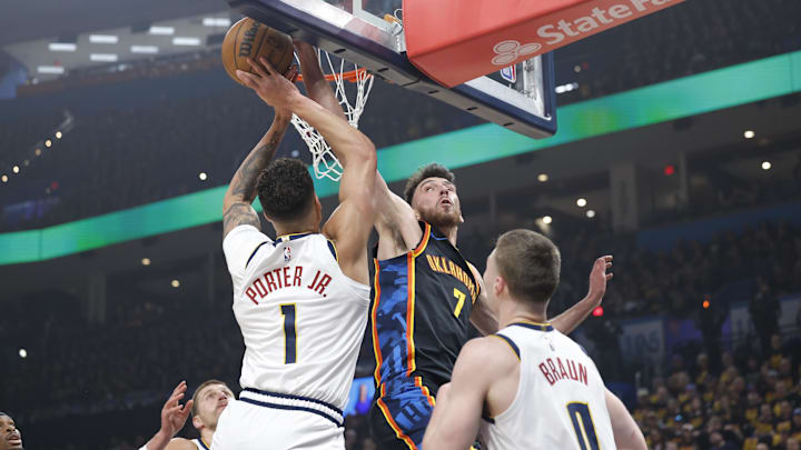 May 5, 2025; Oklahoma City, Oklahoma, USA; Oklahoma City Thunder forward Chet Holmgren (7) blocks a shot by Denver Nuggets forward Michael Porter Jr. (1) during the first quarter during game one of the second round for the 2025 NBA Playoffs at Paycom Center. Mandatory Credit: Alonzo Adams-Imagn Images