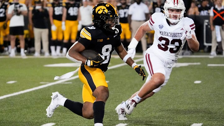 Iowa Hawkeyes running back Terrell Washington Jr. (8) carries the ball as Massachusetts Minutemen defensive lineman Erik Hehl (33) defends Sept. 13, 2025 at Kinnick Stadium in Iowa City, Iowa.