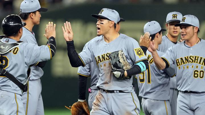 Mar 15, 2025; Bunkyo, Tokyo, Japan; Hanshin Tigers right fielder Teruaki Sato (center) celebrates with teammates after defeating the Chicago Cubs at Tokyo Dome. Mandatory Credit: Darren Yamashita-Imagn Images Mar 15, 2025; Bunkyo, Tokyo, Japan; Hanshin Tigers right fielder Teruaki Sato (center) celebrates with teammates after defeating the Chicago Cubs at Tokyo Dome. Mandatory Credit: Darren Yamashita-Imagn Images