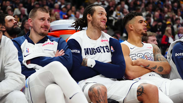Dec 23, 2024; Denver, Colorado, USA; Denver Nuggets center Nikola Jokic (15) and forward Aaron Gordon (32) and forward Michael Porter Jr. (1) on the bench in the fourth quarter against the Phoenix Suns at Ball Arena. Mandatory Credit: Ron Chenoy-Imagn Images