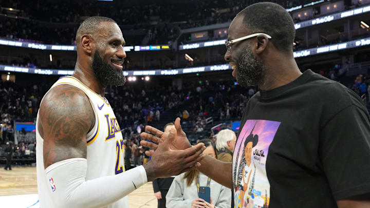 Los Angeles Lakers forward LeBron James (left) talks with Golden State Warriors forward Draymond Green (right) after the game at Chase Center.
