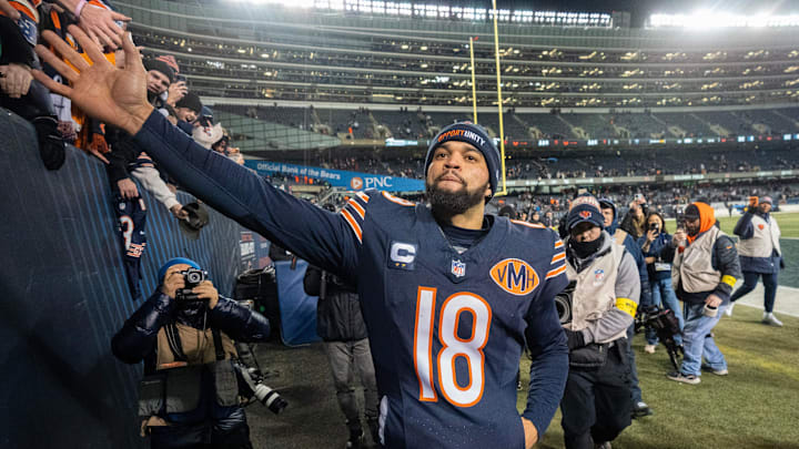 Caleb Williams celebrates with fans at Soldier Field after his 46-yard TD pass to DJ Moore beat the Packers in OT, 22-16.