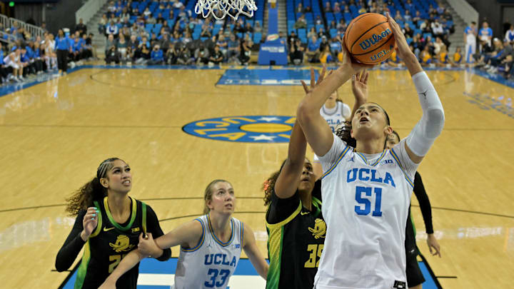 Dec 7, 2025; Los Angeles, California, USA;  UCLA Bruins center Lauren Betts (51) drives past Oregon Ducks forward Ehis Etute (35) for a basket during the first half at Pauley Pavilion presented by Wescom Financial. Mandatory Credit: Jayne Kamin-Oncea-Imagn Images