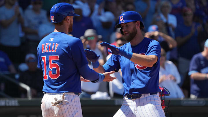 Mar 24, 2025; Mesa, Arizona, USA; Chicago Cubs third base Gage Workman (25) celebrates with catcher Carson Kelly (15) after hitting a two run home run against the Atlanta Braves in the second inning at Sloan Park.