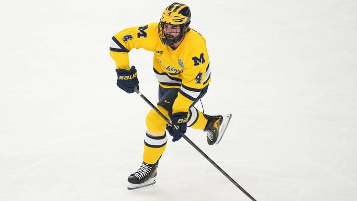 Apr 9, 2026; Las Vegas, Nevada, UNITED STATES; Michigan Wolverines defenseman Asher Barnett (4) moves the puck in the first period against the Denver Pioneers in the semifinals of the NCAA men's ice hockey Frozen Four at T-Mobile Arena. Mandatory Credit: Lucas Peltier-Imagn Images Apr 9, 2026; Las Vegas, Nevada, UNITED STATES; Michigan Wolverines defenseman Asher Barnett (4) moves the puck in the first period against the Denver Pioneers in the semifinals of the NCAA men's ice hockey Frozen Four at T-Mobile Arena. Mandatory Credit: Lucas Peltier-Imagn Images
