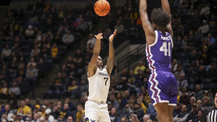 Feb 25, 2025; Morgantown, West Virginia, USA; West Virginia Mountaineers guard Javon Small (7) shoots over TCU Horned Frogs guard Jace Posey (41) during the first half at WVU Coliseum. Mandatory Credit: Ben Queen-Imagn Images