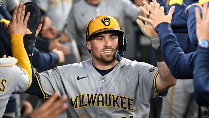Aug 29, 2025; Toronto, Ontario, CAN;  Milwaukee Brewers third baseman Caleb Durbin (21) celebrates with team mates in the dugout after scoring a run against the Toronto Blue Jays in the sixth inning at Rogers Centre. Mandatory Credit: Dan Hamilton-Imagn Images