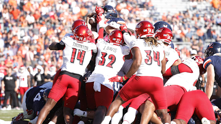 Oct 12, 2024; Charlottesville, Virginia, USA; Virginia Cavaliers quarterback Grady Brosterhous (19) scores a touchdown during the first half against the Louisville Cardinals at Scott Stadium. Mandatory Credit: Amber Searls-Imagn Images Oct 12, 2024; Charlottesville, Virginia, USA; Virginia Cavaliers quarterback Grady Brosterhous (19) scores a touchdown during the first half against the Louisville Cardinals at Scott Stadium. Mandatory Credit: Amber Searls-Imagn Images