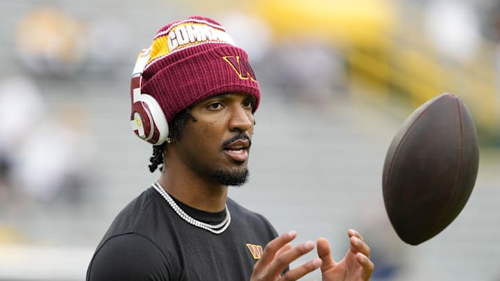Sep 11, 2025; Green Bay, Wisconsin, USA; Washington Commanders quarterback Jayden Daniels (5) warms up before a game against the Green Bay Packers at Lambeau Field. Mandatory Credit: Jeff Hanisch-Imagn Images