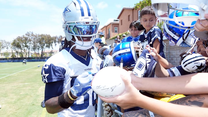 Dallas Cowboys receiver CeeDee Lamb signs autographs during training camp at the River Ridge Fields in Oxnard, California 