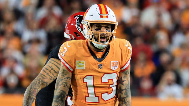 Dec 11, 2025; Tampa, Florida, USA; Tampa Bay Buccaneers wide receiver Mike Evans (13) reacts after catching a pass against Atlanta Falcons safety Jessie Bates III (3) (obscured) during the third quarter at Raymond James Stadium. Mandatory Credit: Kim Klement Neitzel-Imagn Images