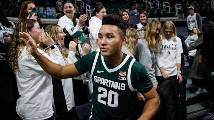 Michigan State guard Nick Sanders (20) high-fives fans after 74-51 win over Southern Indiana at Breslin Center in East Lansing on Thursday, Nov. 9, 2023.