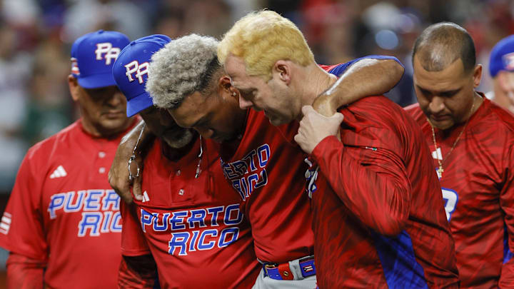 Mar 15, 2023; Miami, Florida, USA; Puerto Rico pitcher Edwin Diaz (39) gets taken off the field by pitching coach Ricky Bones (27) after an apparent leg injury during the team celebration against Dominican Republic at LoanDepot Park. Mandatory Credit: Sam Navarro-Imagn Images Mar 15, 2023; Miami, Florida, USA; Puerto Rico pitcher Edwin Diaz (39) gets taken off the field by pitching coach Ricky Bones (27) after an apparent leg injury during the team celebration against Dominican Republic at LoanDepot Park. Mandatory Credit: Sam Navarro-Imagn Images