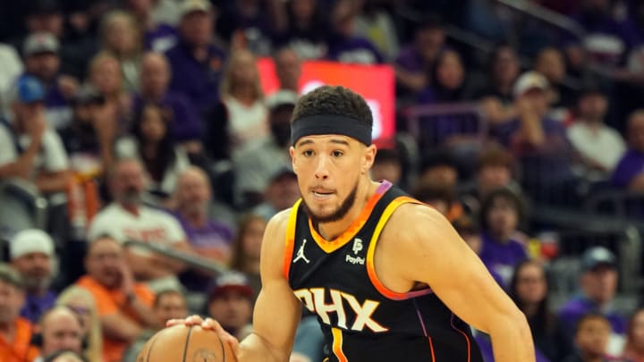 Apr 26, 2024; Phoenix, Arizona, USA; Phoenix Suns guard Devin Booker (1) dribbles against the Minnesota Timberwolves during the second half of game three of the first round for the 2024 NBA playoffs at Footprint Center. Mandatory Credit: Joe Camporeale-USA TODAY Sports